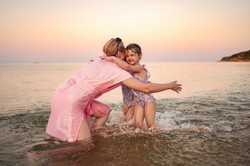 Joyful family moments at the beach during sunset
