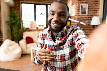 Pov of self employed black man creating video content for online viewers, sharing business...