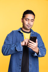 Indian man adding payment method on online website with his card, delighted to take advantage of...