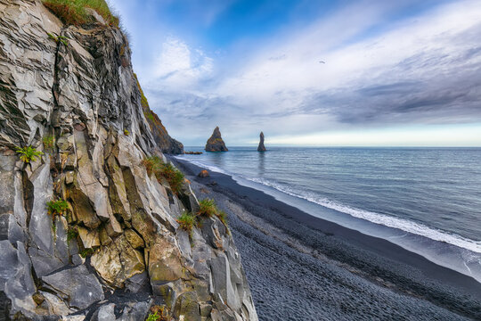 Ramarkable landscape with basalt rock formations Troll Toes on Black beach Reynisfjara near the village of Vik.