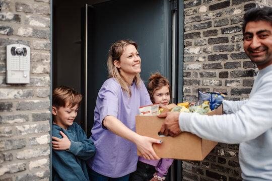 Engaging grocery delivery scene at family's home