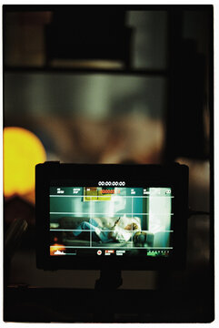 Camera shooting woman on couch