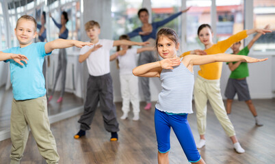 Girls with boys repeat teaches sequences of movements during training, train to perform electro...