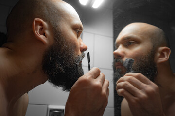 Man Dyeing Beard in Front of Mirror 