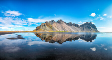 Amazing  sunny day and gorgeous reflection of Vestrahorn mountaine on Stokksnes cape in Iceland.