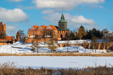 Ancient medieval village church and frozen winter river
