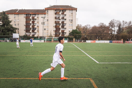 Boy running during a soccer game on a field