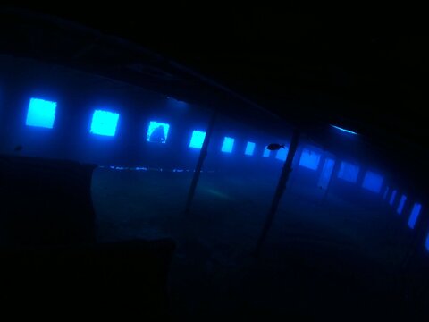 scuba divers exploring shipwreck  underwater 