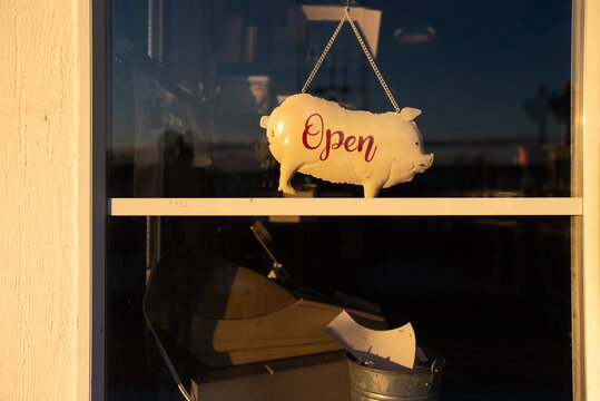 Open Pig sign on the door of a business 