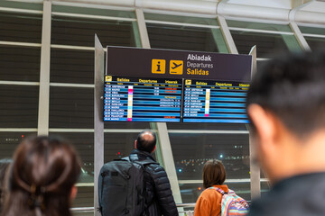 Passengers looking at cancelled flight information