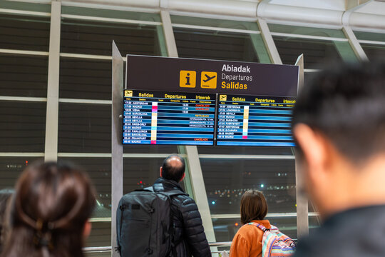 Passengers looking at cancelled flight information - Powered by Adobe