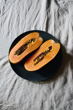 Two slices of papaya on a plate