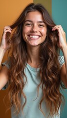 Joyful young woman with long wavy hair smiling brightly