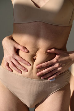female hands stroked female stomach