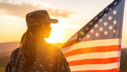 Soldier Silhouette Against Sunset with American Flag in Background