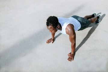 Determined athlete doing push-ups during intense outdoor workout