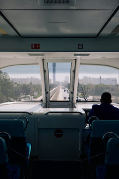 The driver of a monorail and an iconic Dubai Palm Jumeirah skyline.