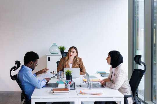 Investors discussing possibilities of allocating capital at office