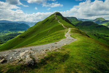Summer landscape featuring the hiking trail winding up Catbells fell, reaching the summit in the Lake District.
