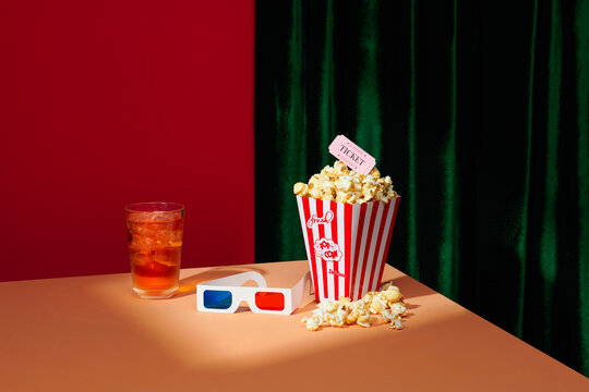 Bucket of popcorn against a blue background