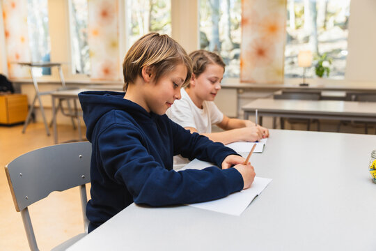 Focused Students Writing in Classroom