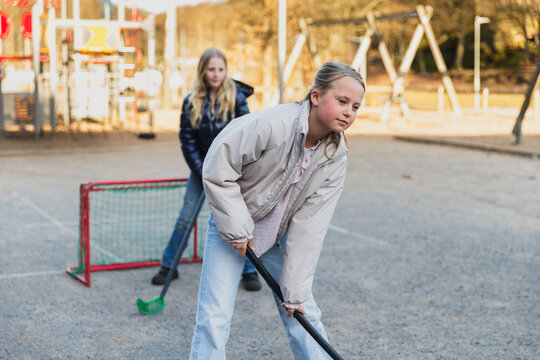 Children Playing Floorball on Playground