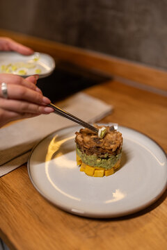 Woman decorating salad with circle of scallion 