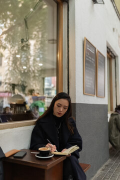 Journalist taking notes in notebook