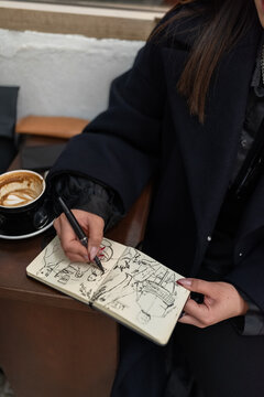 Anonymous artist drawing in sketchbook