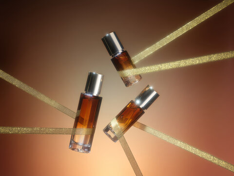 Elegant amber perfume bottles interlaced with gold ribbons