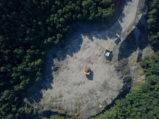 Aerial view of heavy quarry dump trucks.