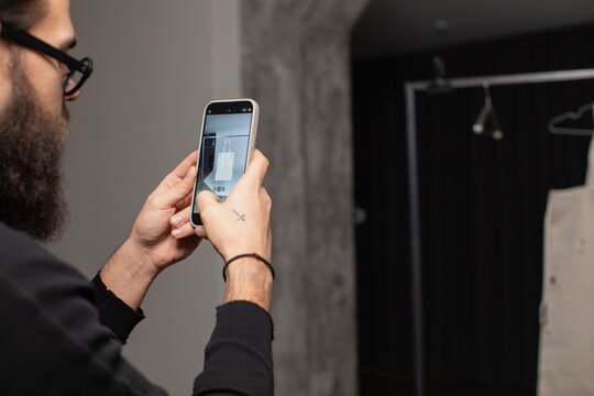 man taking picture with phone 
