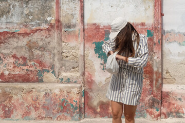 Woman Posing Against Weathered Wall