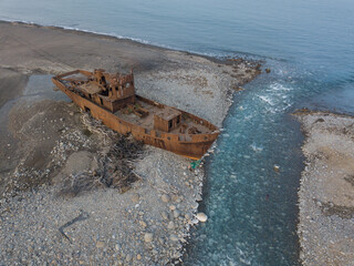 A small ship washed up on the shore.