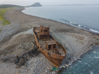 A small ship washed up on the shore.