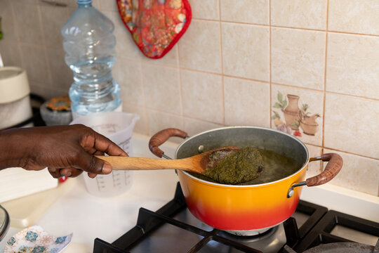 Cooking the cassava leaves in a saucepan