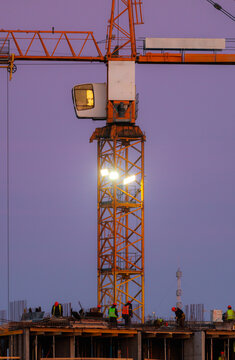 Tower crane at dusk at construction site