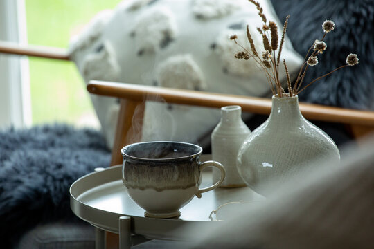 Cup of tea on. side table in a cosy room
