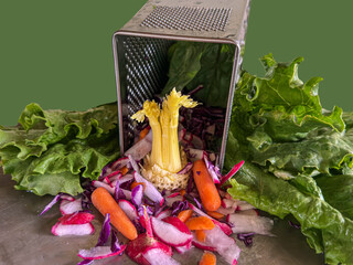 Vegetable display with text space shows grater colander  in kitchen with fresh produce. Lettuce...