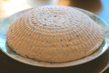 Traditional Polish Easter pascha dessert made from twaróg cheese, shaped and chilled on a plate, festive homemade sweet dish with dried fruits, holiday food photography