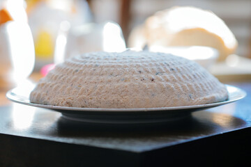 Traditional Polish Easter pascha dessert made from twaróg cheese, shaped and chilled on a plate, festive homemade sweet dish with dried fruits, holiday food photography