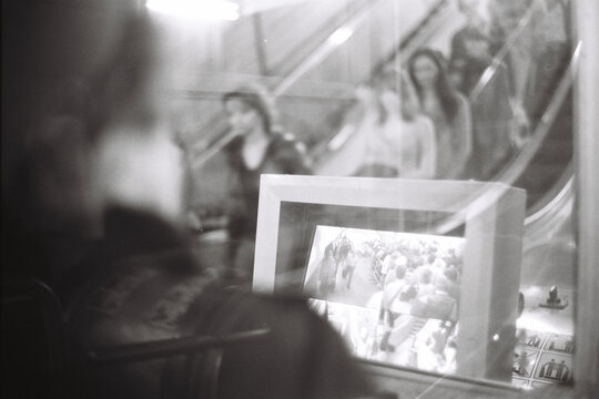 Urban Life Reflected: Escalator and Monitor Scene