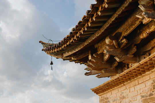 Traditional wooden temple roof with bell
