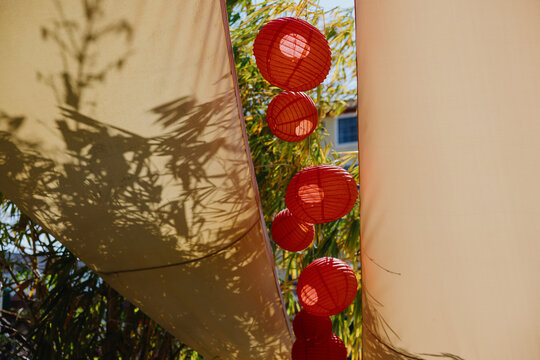 Red Lanterns Hanging Between Fabric Canopies
