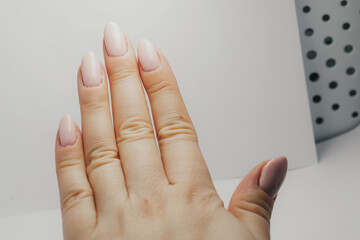 Close-up of poorly done gel manicure with visible cuticle overpainting and uneven nail polish application, educational beauty reference on nail care mistakes