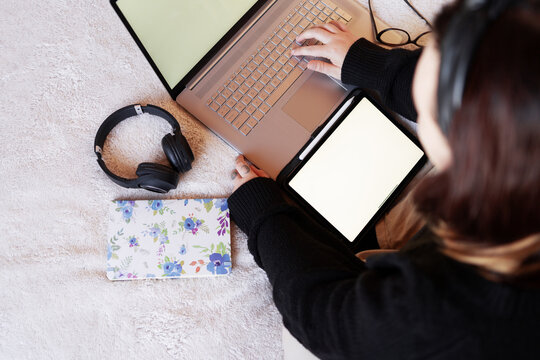 Home workspace essentials: bed, laptop, tablet