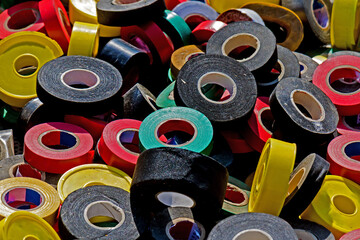 Large pile of colorful insulated tapes sold outside on flea market stall