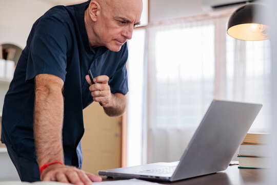 Retired business man reviewing files on computer