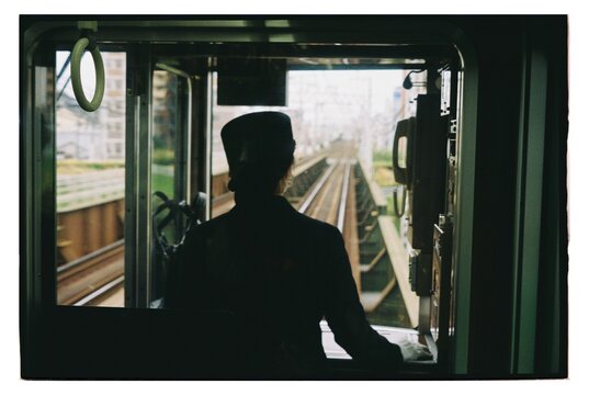 Train operator views the railway tracks during a journey 