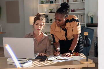 Colleagues Collaborating on Work at Office Desk